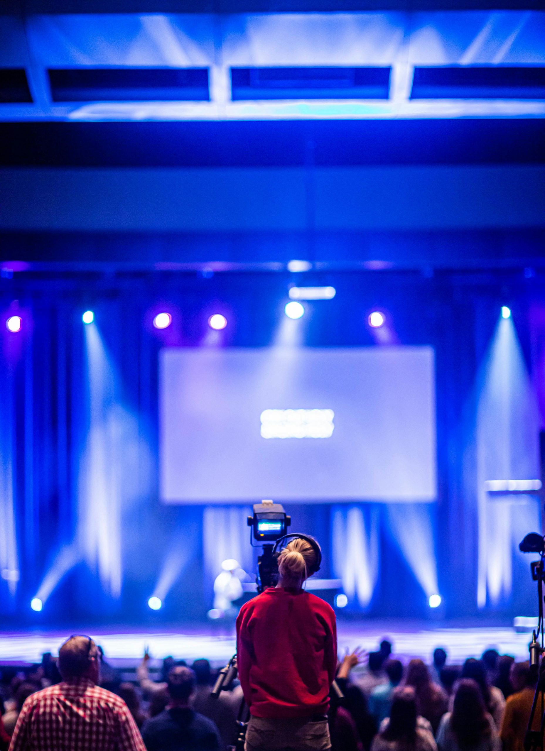 Lighting and camera crews set-up for a large presentation